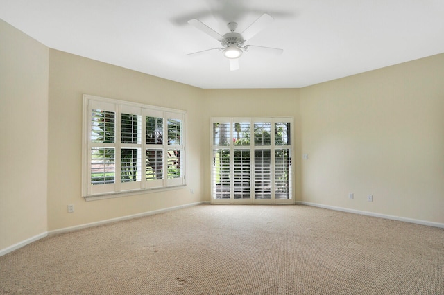 carpeted empty room featuring ceiling fan