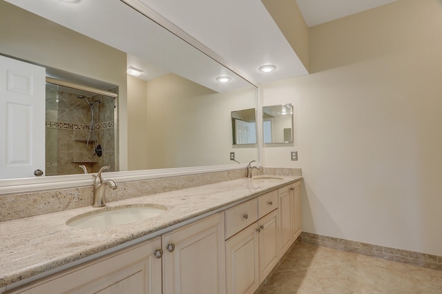 bathroom featuring vanity, tile patterned flooring, and a tile shower