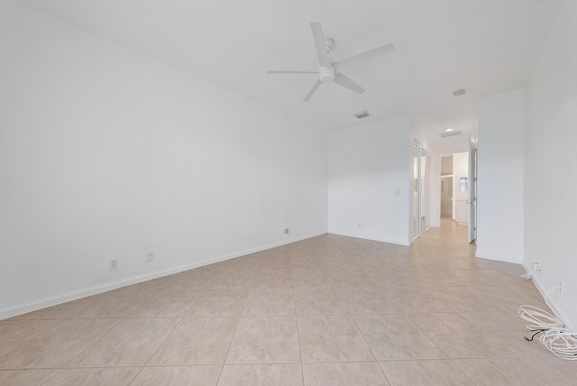 unfurnished room featuring light tile patterned floors and ceiling fan