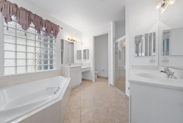 full bathroom with shower with separate bathtub, vanity, toilet, and a wealth of natural light