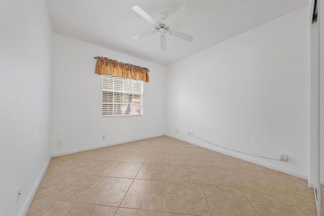 tiled spare room with ceiling fan