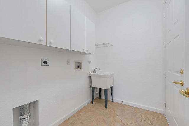 laundry area featuring hookup for a washing machine, light tile patterned flooring, electric dryer hookup, and cabinets