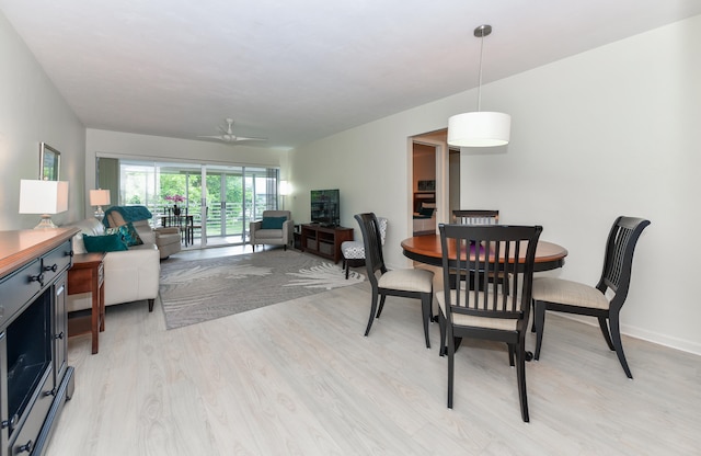 dining space featuring ceiling fan and light hardwood / wood-style flooring