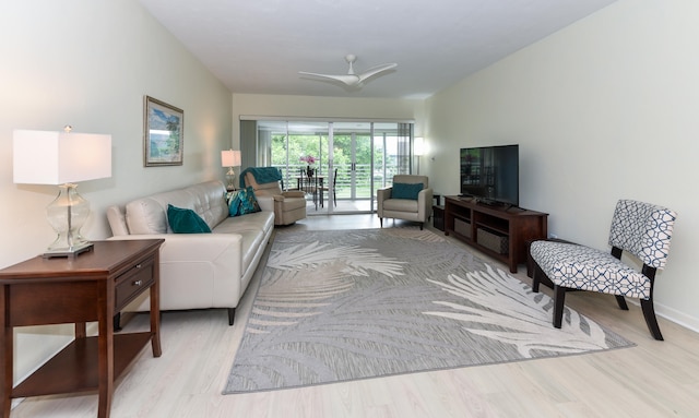 living room featuring light wood-type flooring and ceiling fan