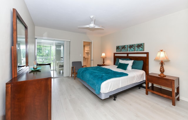 bedroom with ceiling fan, a spacious closet, a closet, light wood-type flooring, and access to outside