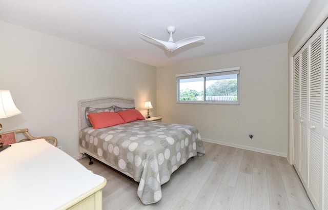 bedroom featuring a closet, light wood-type flooring, and ceiling fan