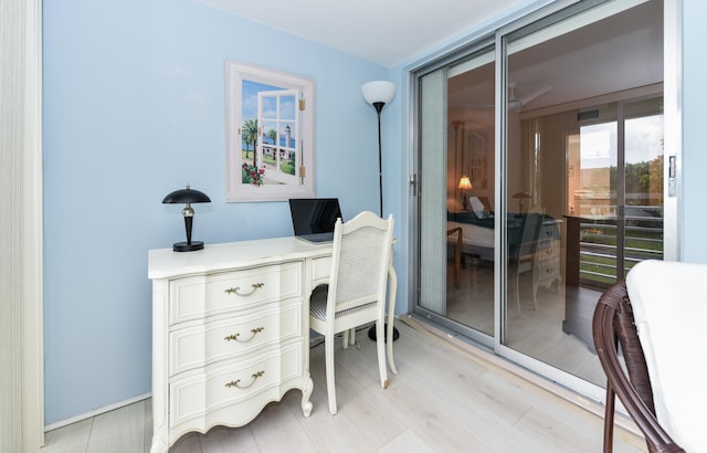 office featuring light hardwood / wood-style floors and a wall of windows