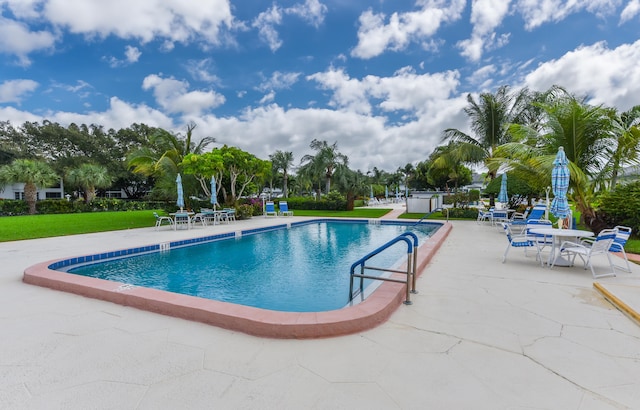 view of pool with a yard and a patio area