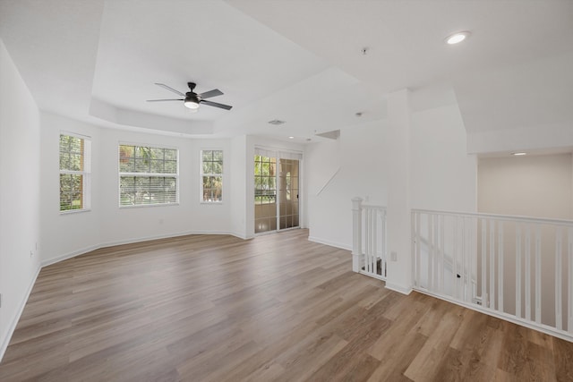 unfurnished living room with light wood-type flooring and ceiling fan