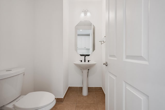 bathroom with tile patterned flooring and toilet