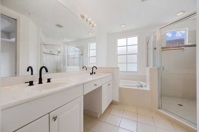 bathroom with a wealth of natural light, vanity, and separate shower and tub