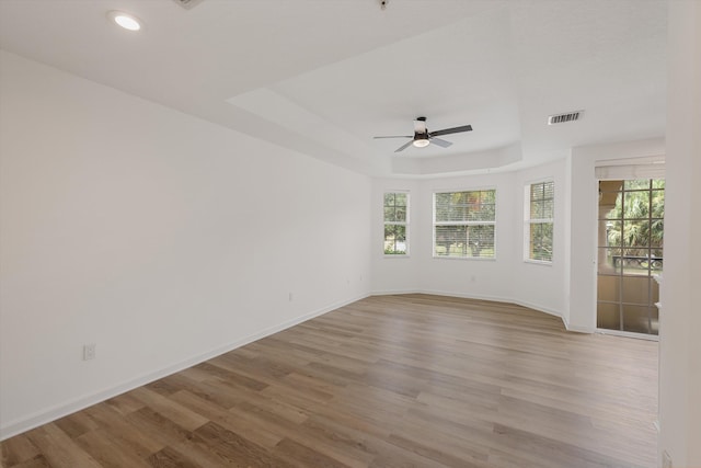 unfurnished room featuring ceiling fan, light wood-type flooring, and plenty of natural light