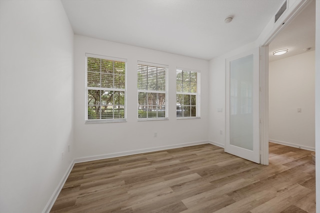 spare room with light wood-type flooring