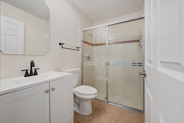 bathroom with tile patterned flooring, a textured ceiling, a shower with shower door, vanity, and toilet