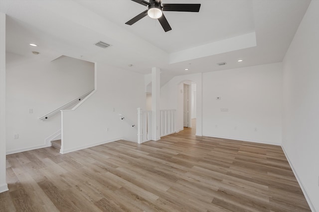 unfurnished living room featuring ceiling fan and light hardwood / wood-style floors