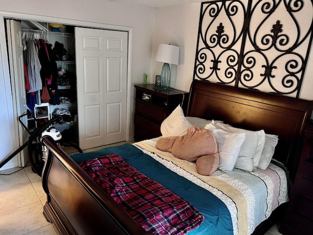 bedroom with light tile patterned flooring and a closet