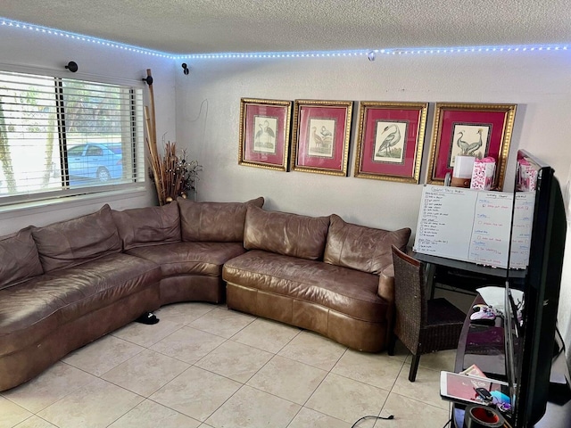 tiled living room featuring a textured ceiling