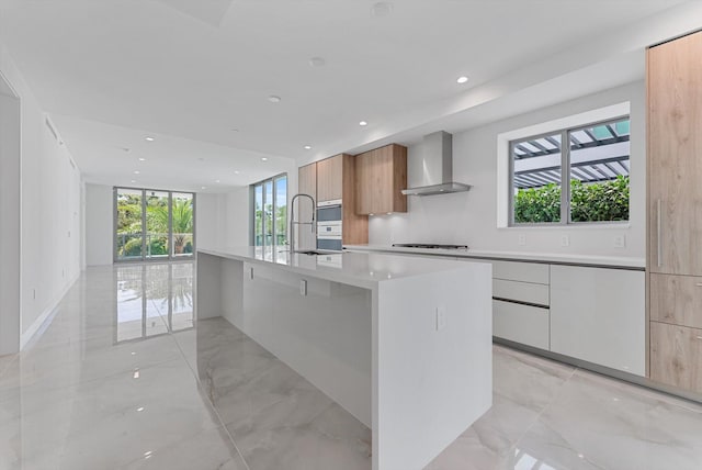 485 E Royal Palm Rd Unit 204, Boca Raton, FL 33432 - kitchen with modern cabinets, wall chimney range hood, a sink, light countertops, and gas cooktop