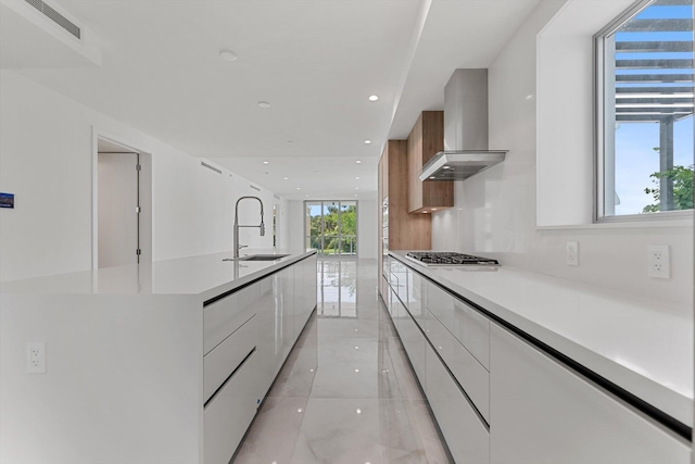 485 E Royal Palm Rd Unit 204, Boca Raton, FL 33432 - kitchen with modern cabinets, wall chimney exhaust hood, a sink, white cabinets, and light countertops