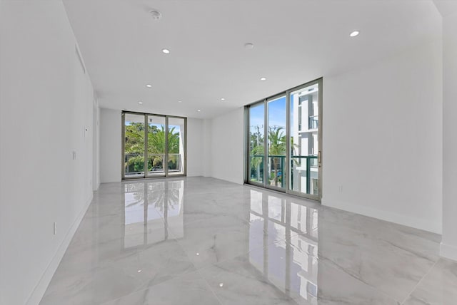 485 E Royal Palm Rd Unit 204, Boca Raton, FL 33432 - spare room with a wall of windows, light marble finish floors, and recessed lighting