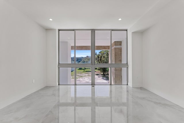 485 E Royal Palm Rd Unit 204, Boca Raton, FL 33432 - empty room with a wall of windows, marble tiled flooring, baseboards, and recessed lighting