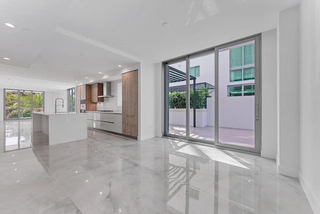 485 E Royal Palm Rd Unit 204, Boca Raton, FL 33432 - unfurnished living room with light marble finish flooring, recessed lighting, a sink, and a wall of windows