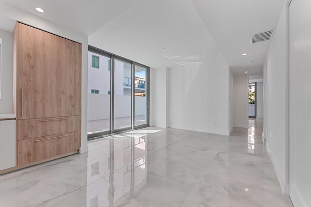 485 E Royal Palm Rd Unit 204, Boca Raton, FL 33432 - spare room featuring light marble finish flooring, recessed lighting, baseboards, and floor to ceiling windows