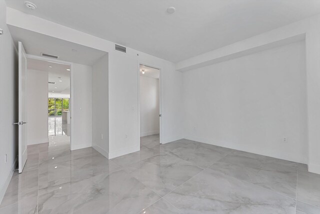 485 E Royal Palm Rd Unit 204, Boca Raton, FL 33432 - empty room featuring marble tiled floors, a smoke detector, and baseboards