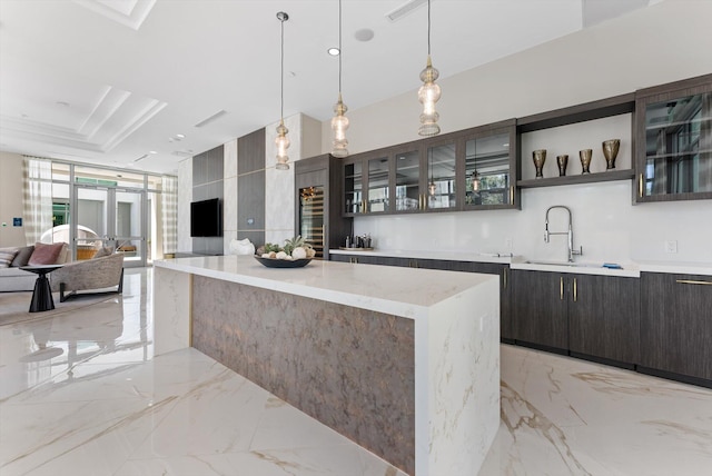 485 E Royal Palm Rd Unit 204, Boca Raton, FL 33432 - kitchen with a sink, light marble finish flooring, a center island, and glass insert cabinets
