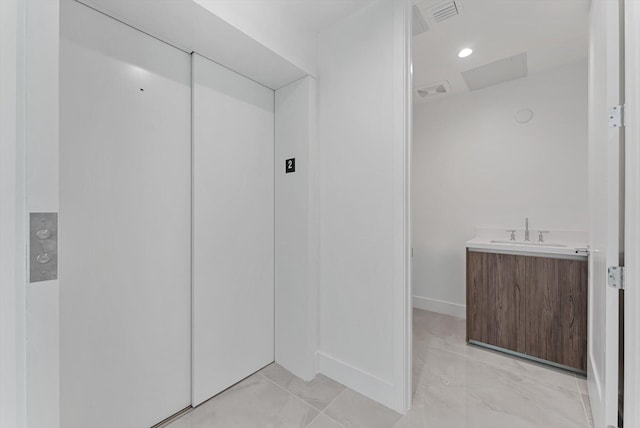 485 E Royal Palm Rd Unit 204, Boca Raton, FL 33432 - bathroom featuring elevator, baseboards, and vanity