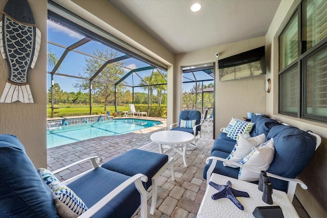 view of swimming pool featuring an outdoor hangout area, glass enclosure, and a patio area