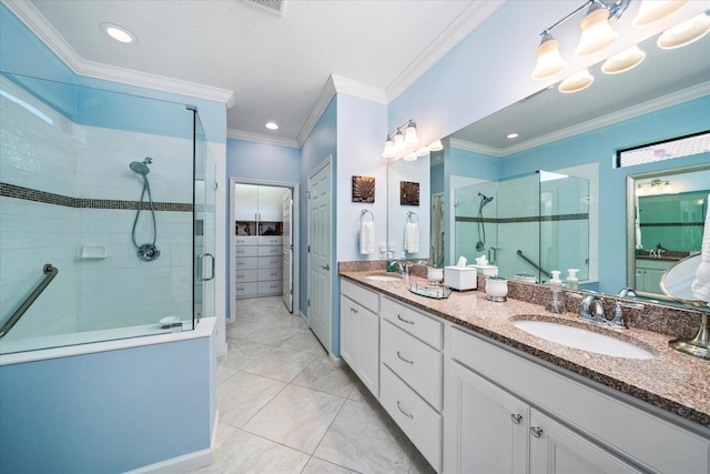 bathroom with ornamental molding, a shower with shower door, and vanity