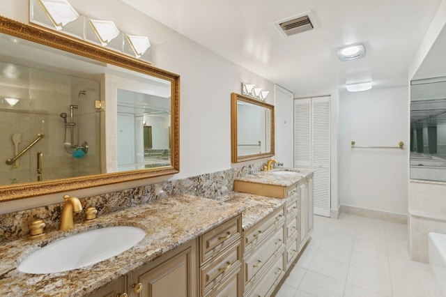 bathroom with vanity, tile patterned floors, and a shower with door