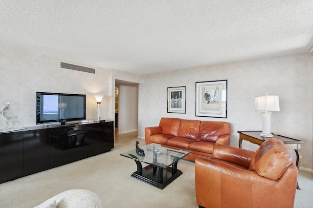 carpeted living room with a textured ceiling