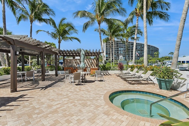 view of swimming pool featuring a pergola, a patio, and a community hot tub