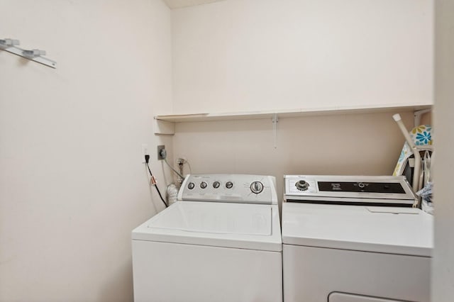 clothes washing area with washer and clothes dryer