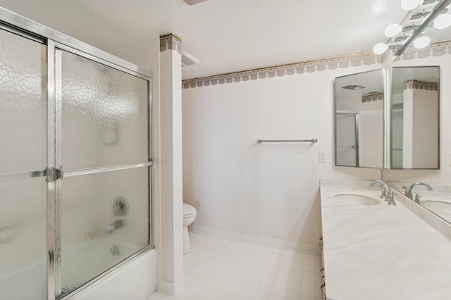 full bathroom featuring toilet, bath / shower combo with glass door, and vanity