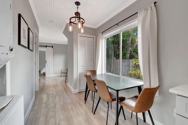 dining room with ornamental molding, light hardwood / wood-style flooring, a barn door, and wood ceiling