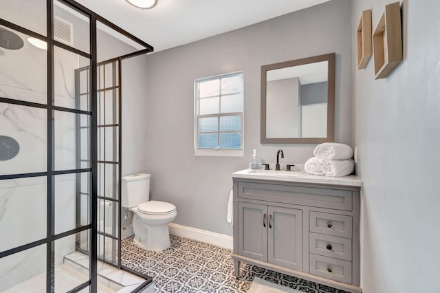 bathroom with vanity, toilet, and tile patterned floors