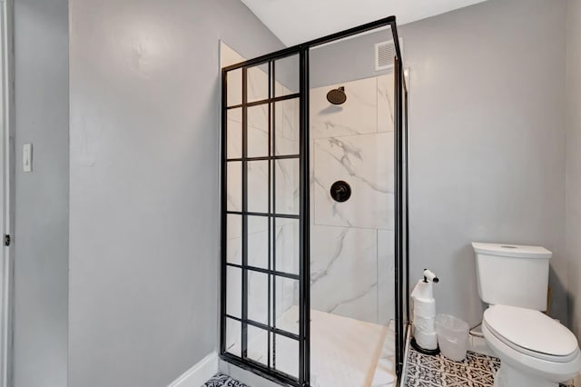 bathroom featuring a shower with shower door, toilet, and tile patterned floors