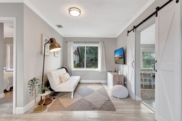 sitting room featuring light wood-type flooring and crown molding