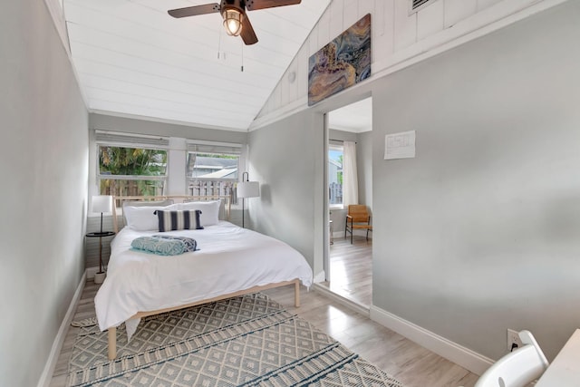 bedroom with ceiling fan, light hardwood / wood-style flooring, and high vaulted ceiling