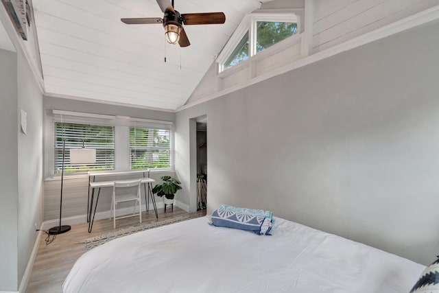 bedroom featuring light hardwood / wood-style floors, ceiling fan, and high vaulted ceiling