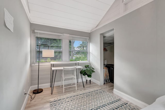 office with ornamental molding, light wood-type flooring, and vaulted ceiling