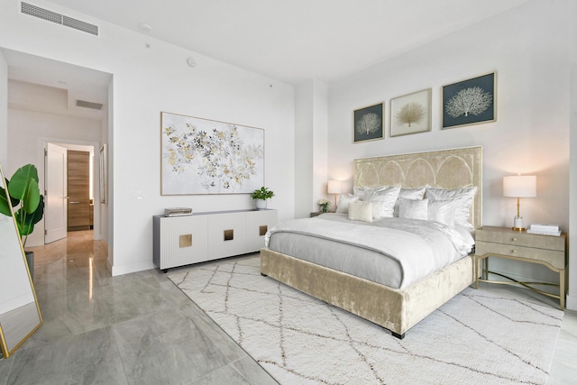 bedroom with marble finish floor and visible vents