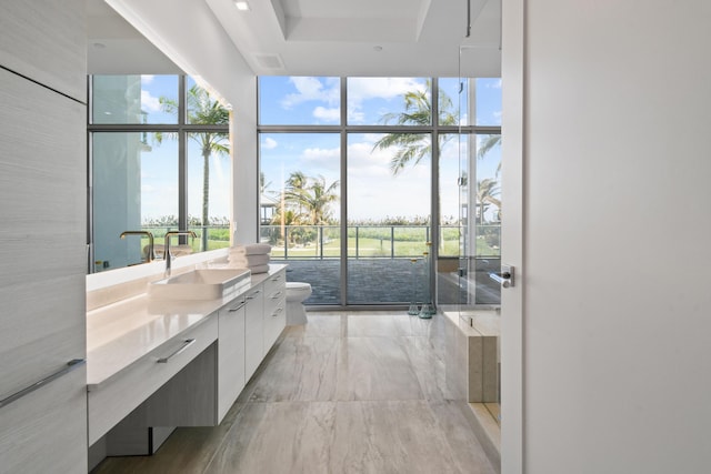 bathroom with floor to ceiling windows, a bath, vanity, marble finish floor, and toilet