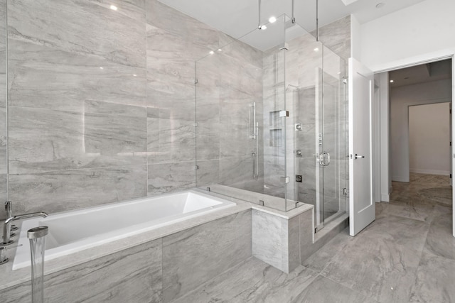 full bath with a bath, marble finish floor, and a stall shower