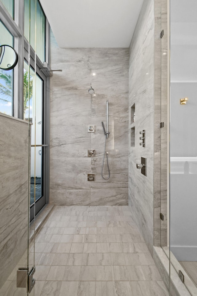 bathroom featuring a shower with door