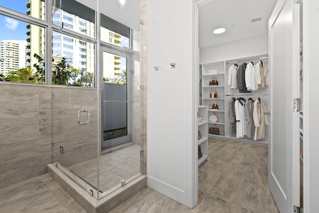 bathroom with a shower with door