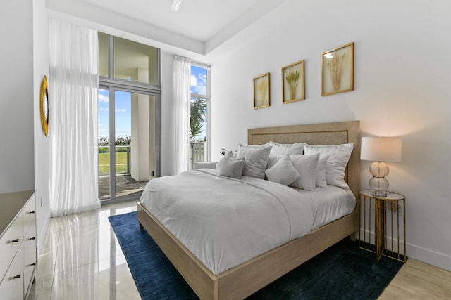 bedroom with baseboards and access to exterior